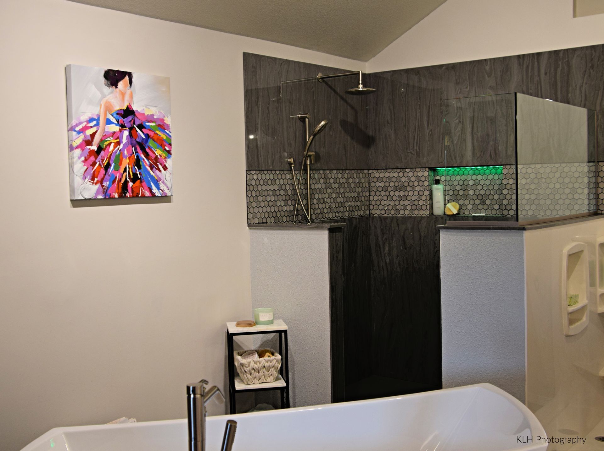 A bathroom with a bathtub and a painting on the wall