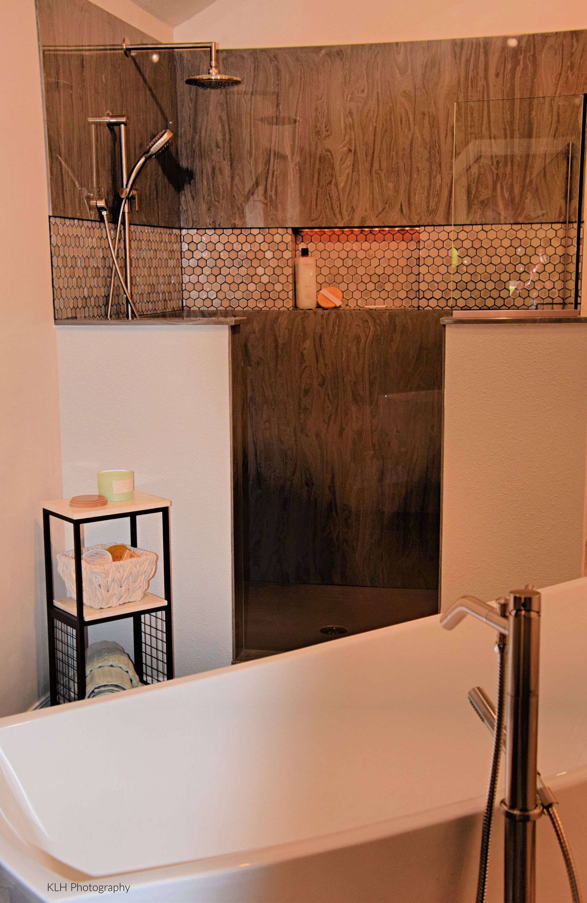 A bathroom with a bathtub and a shower.