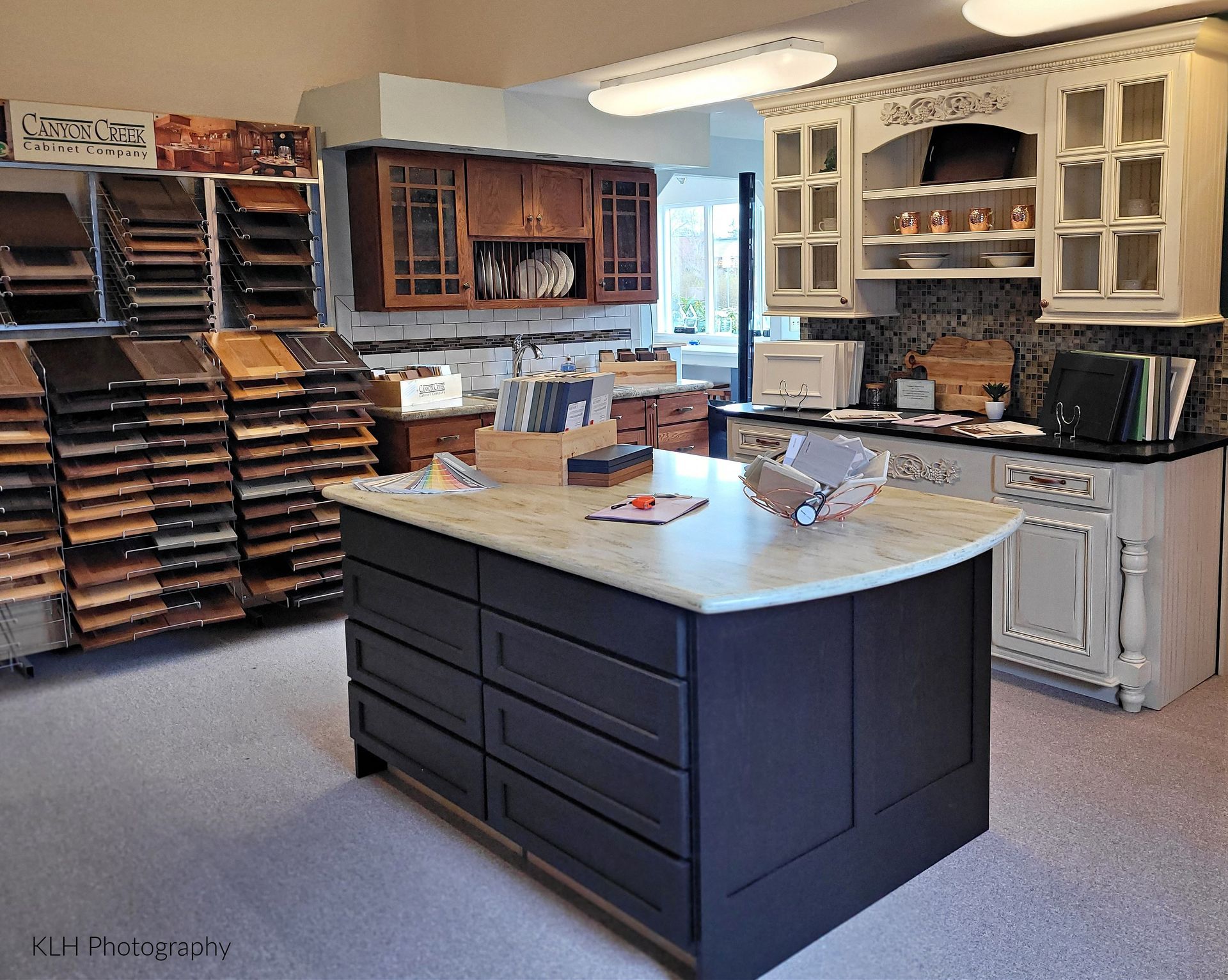 A kitchen with lots of cabinets and a large island