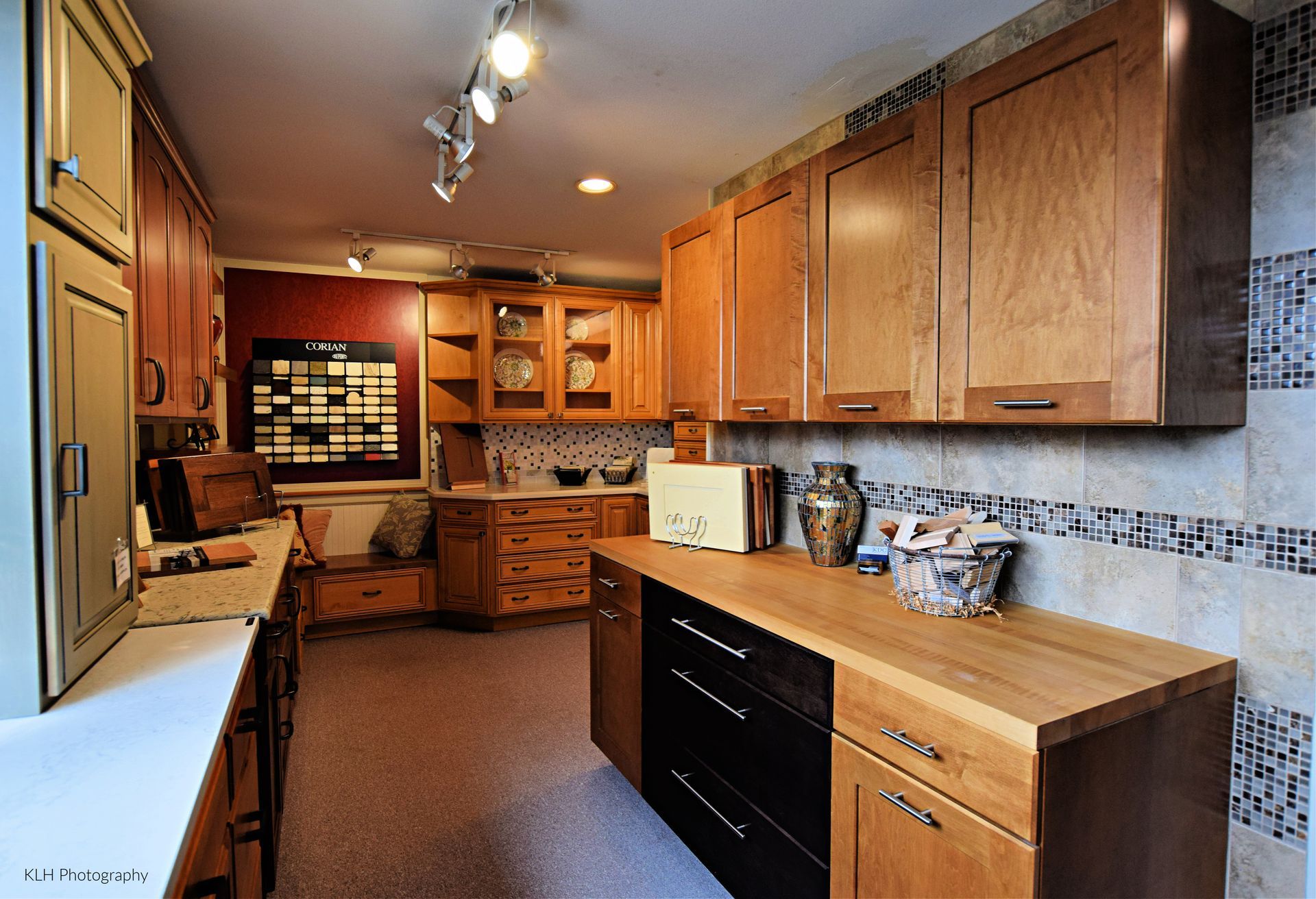 A kitchen with wooden cabinets and black drawers