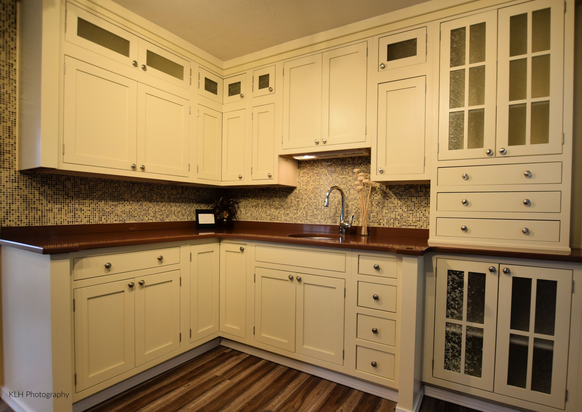 A kitchen with white cabinets and a sink