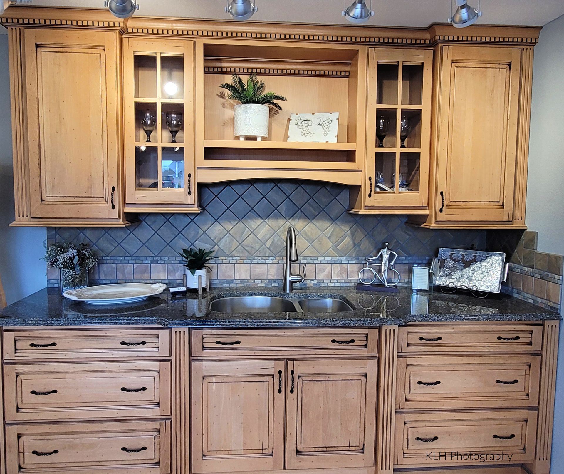 A kitchen with wooden cabinets and granite counter tops