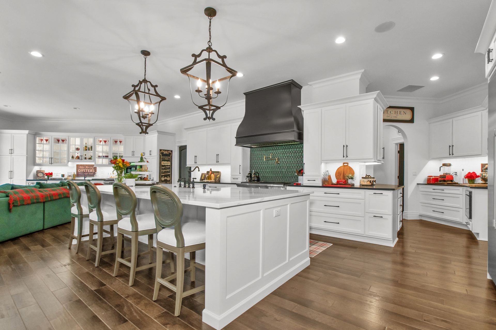 A large kitchen with white cabinets and a large island in the middle.