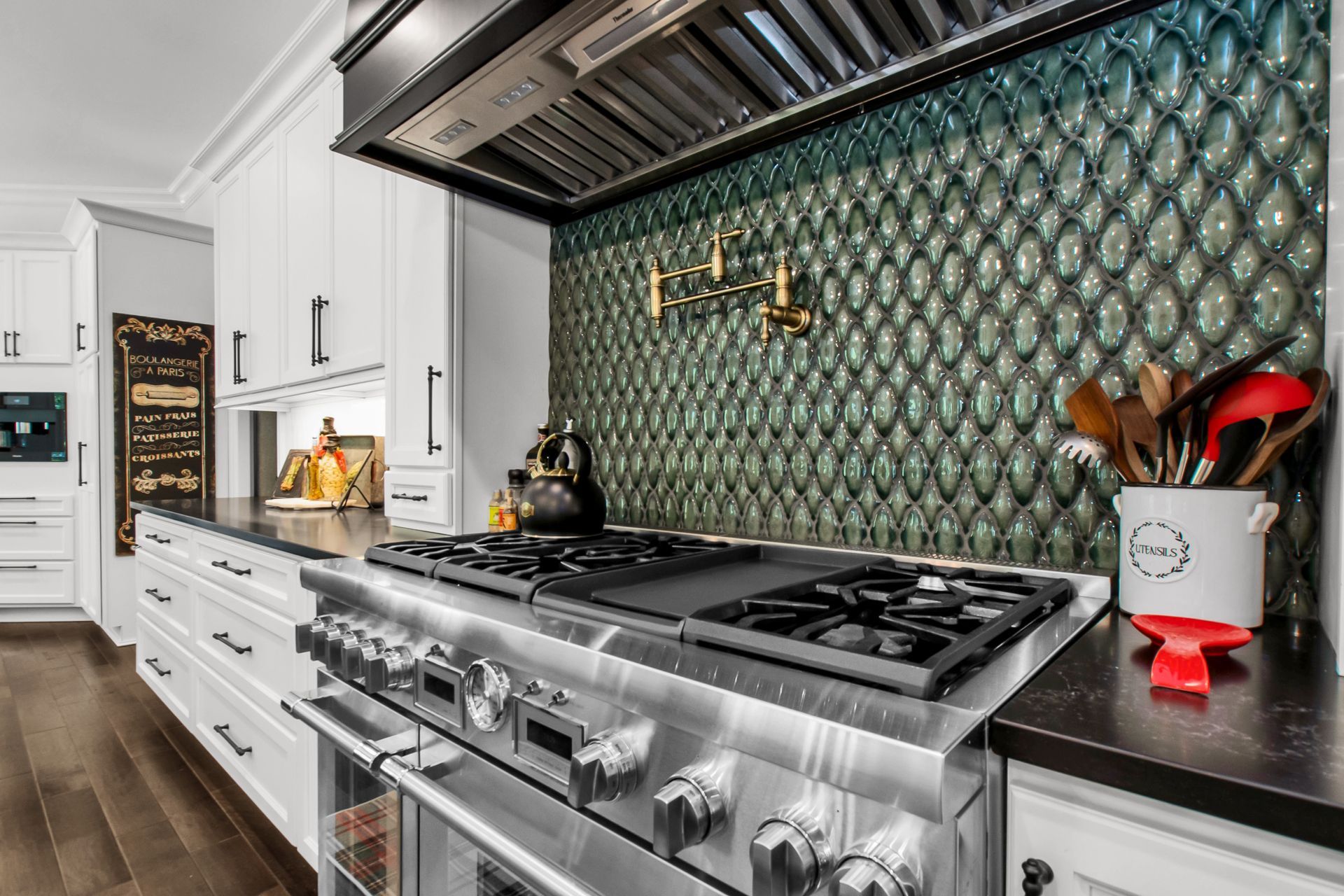 A kitchen with a stove , oven , and microwave.