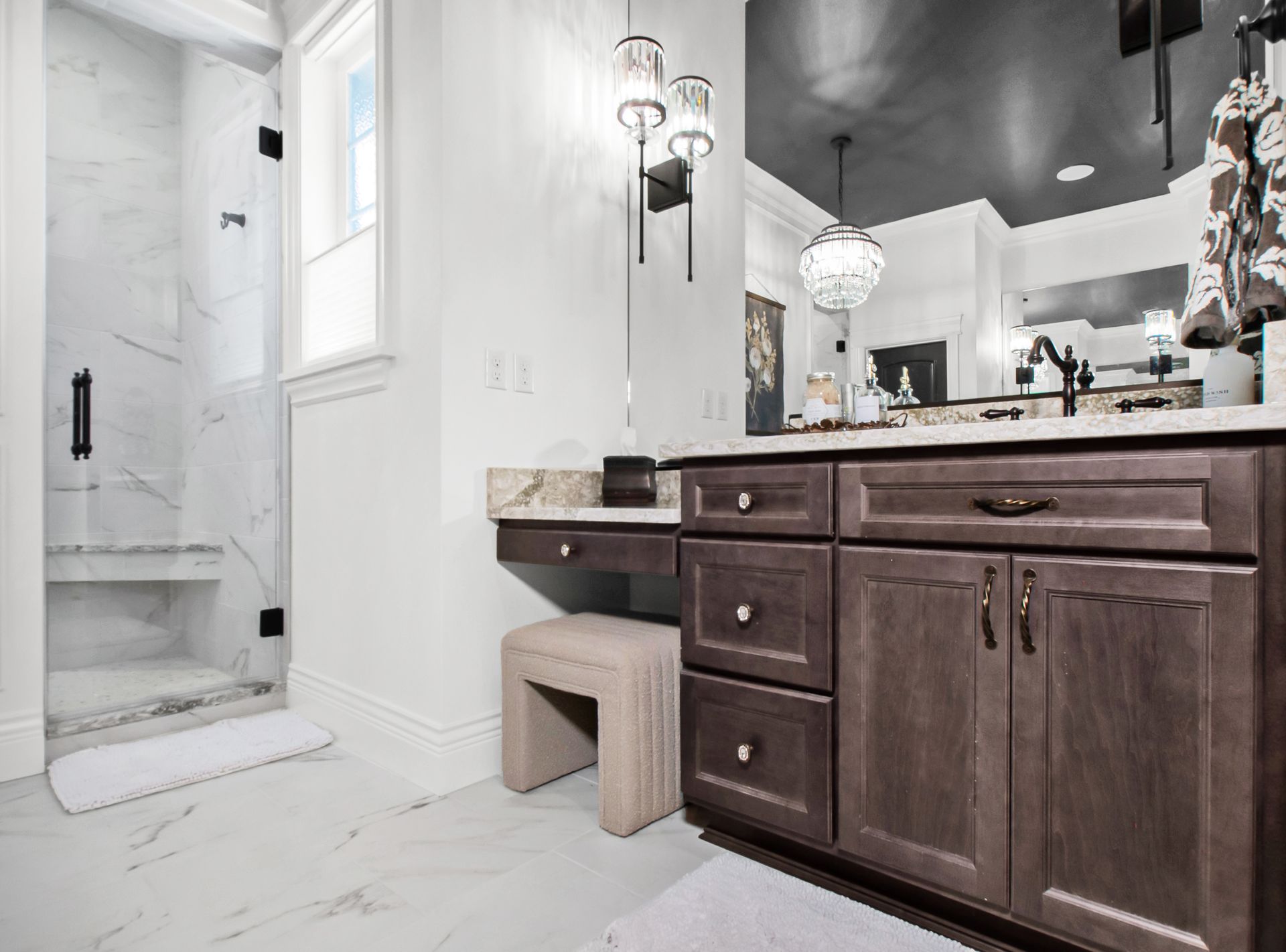 A bathroom with a vanity , sink , mirror and walk in shower.