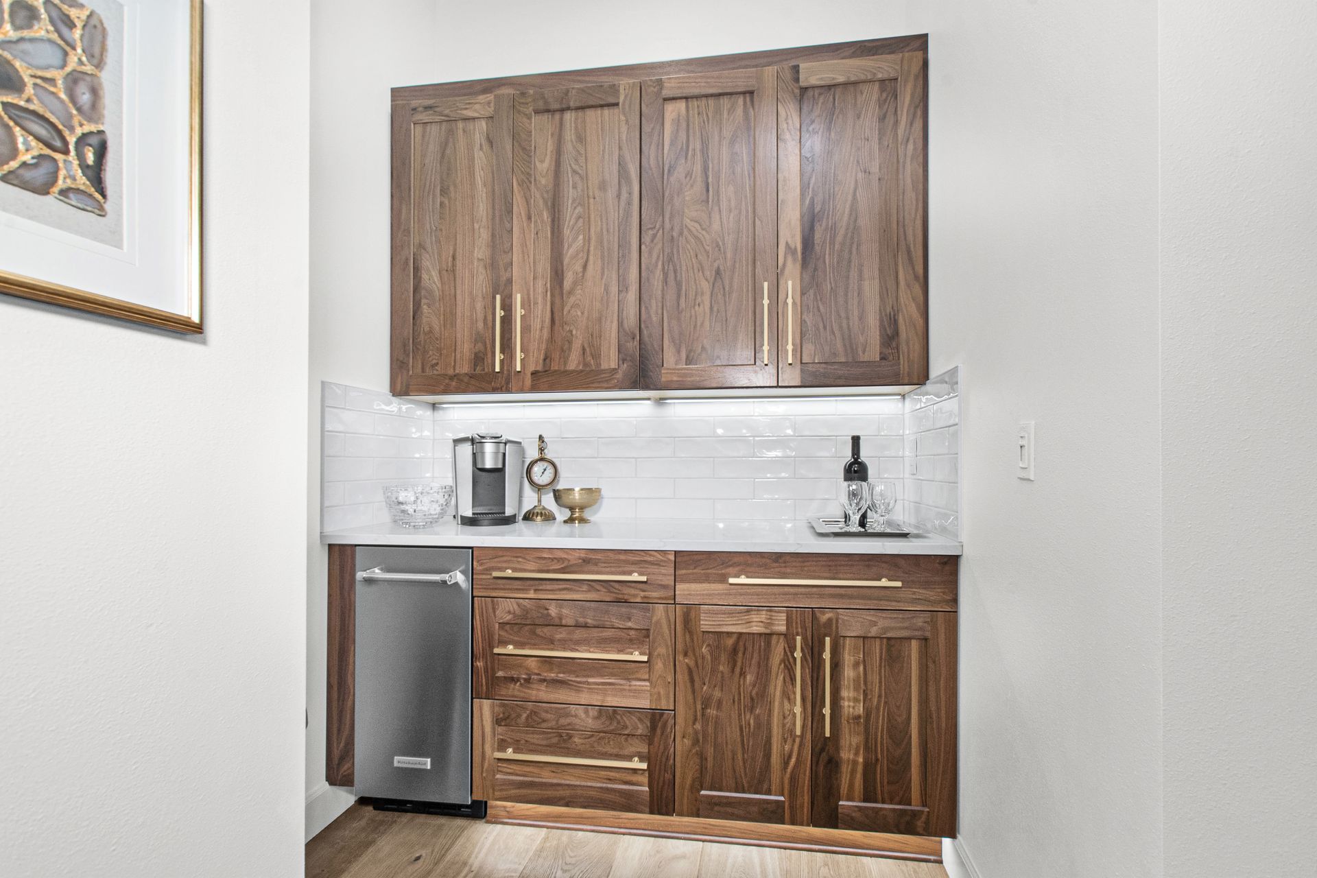 A kitchen with wooden cabinets and a stainless steel dishwasher.