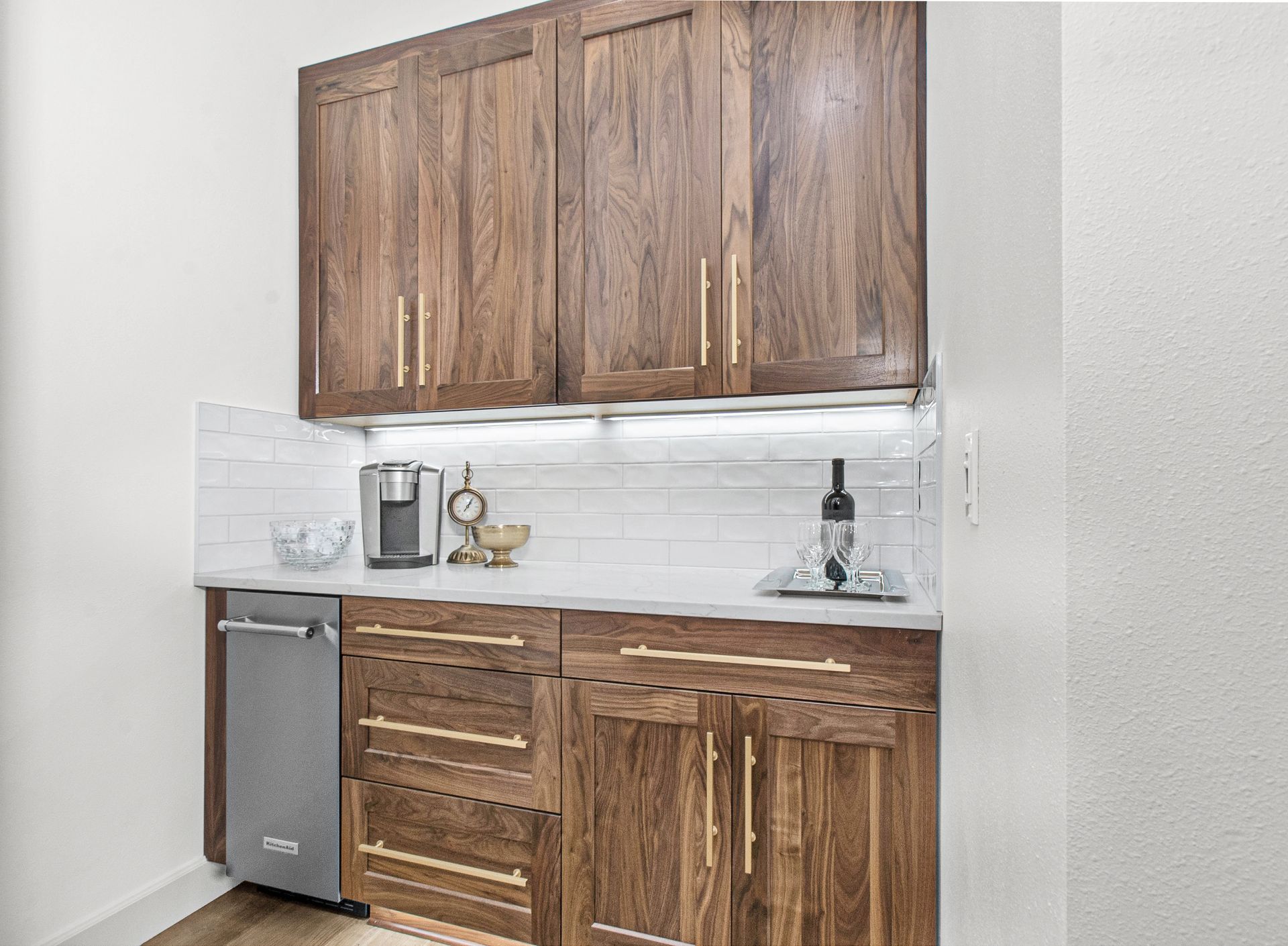 A kitchen with wooden cabinets and a stainless steel dishwasher.