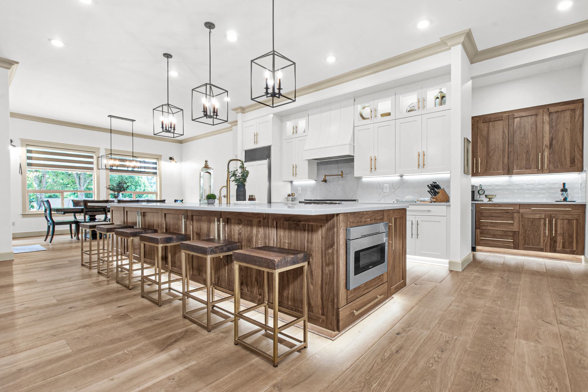 A large kitchen with a large island and stools.