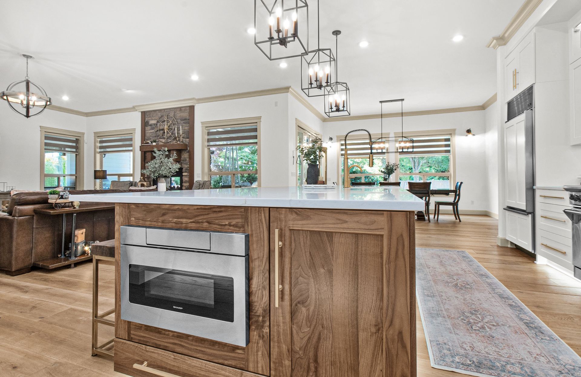 A kitchen with a large island and a microwave oven.