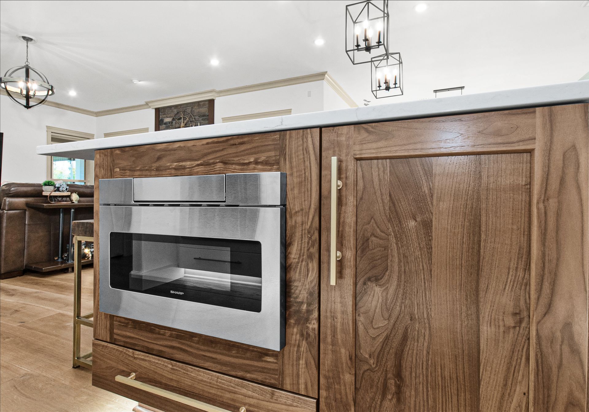 A kitchen with wooden cabinets and a stainless steel microwave oven.