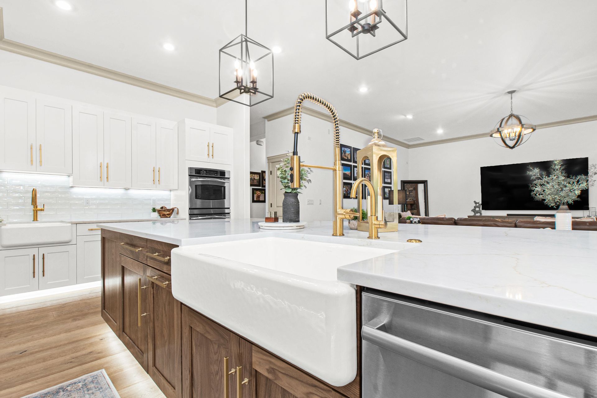 A kitchen with a large sink and a stainless steel dishwasher.