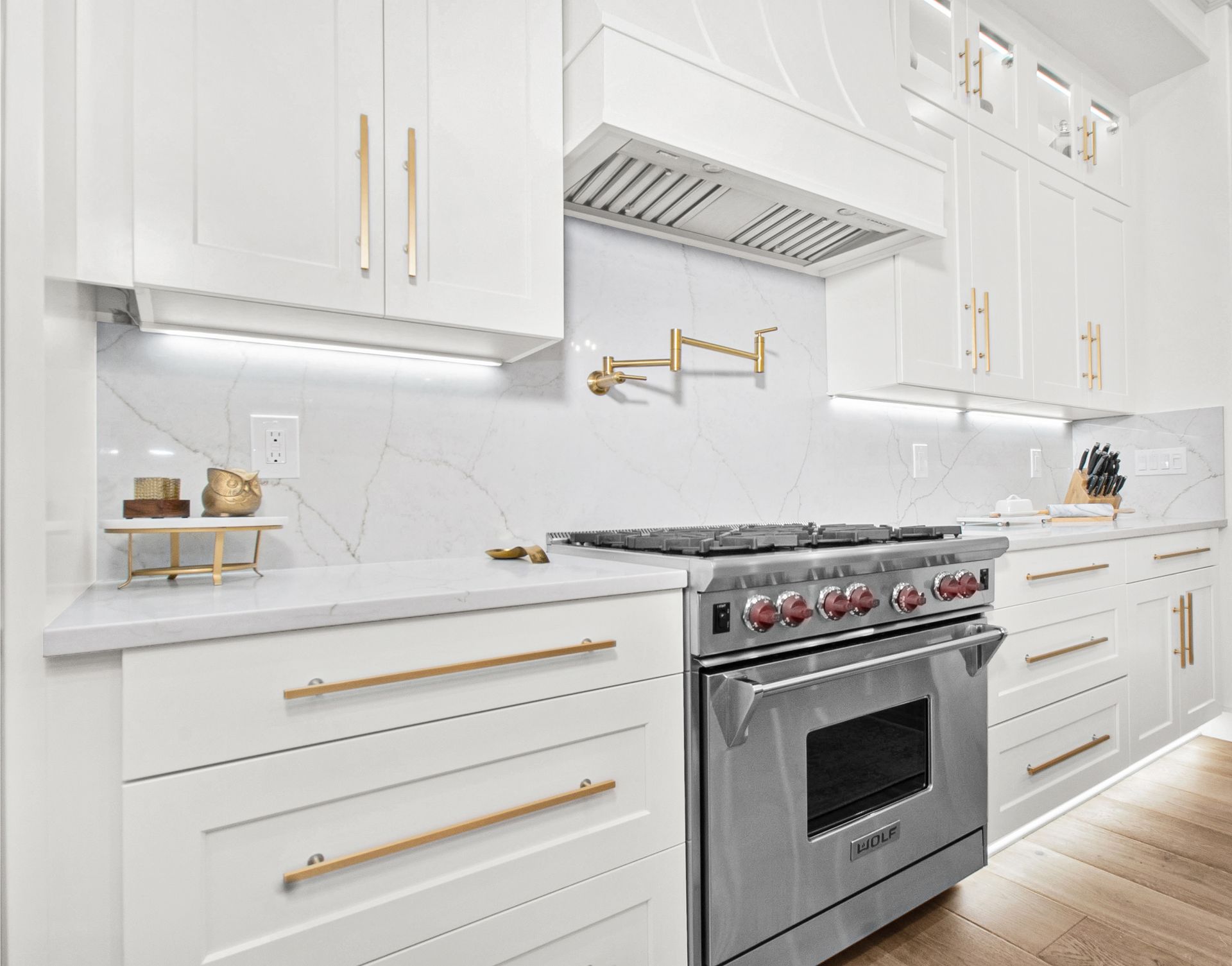 A kitchen with white cabinets and stainless steel appliances.