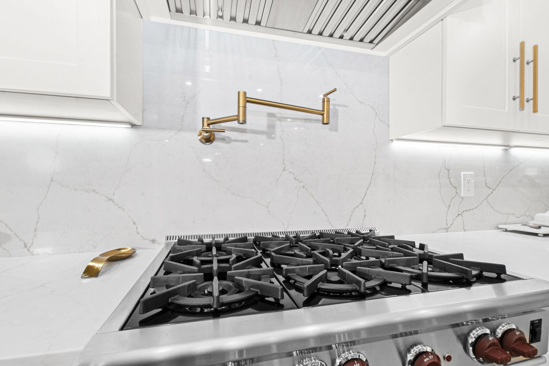 A stove top oven is sitting on top of a white counter in a kitchen.
