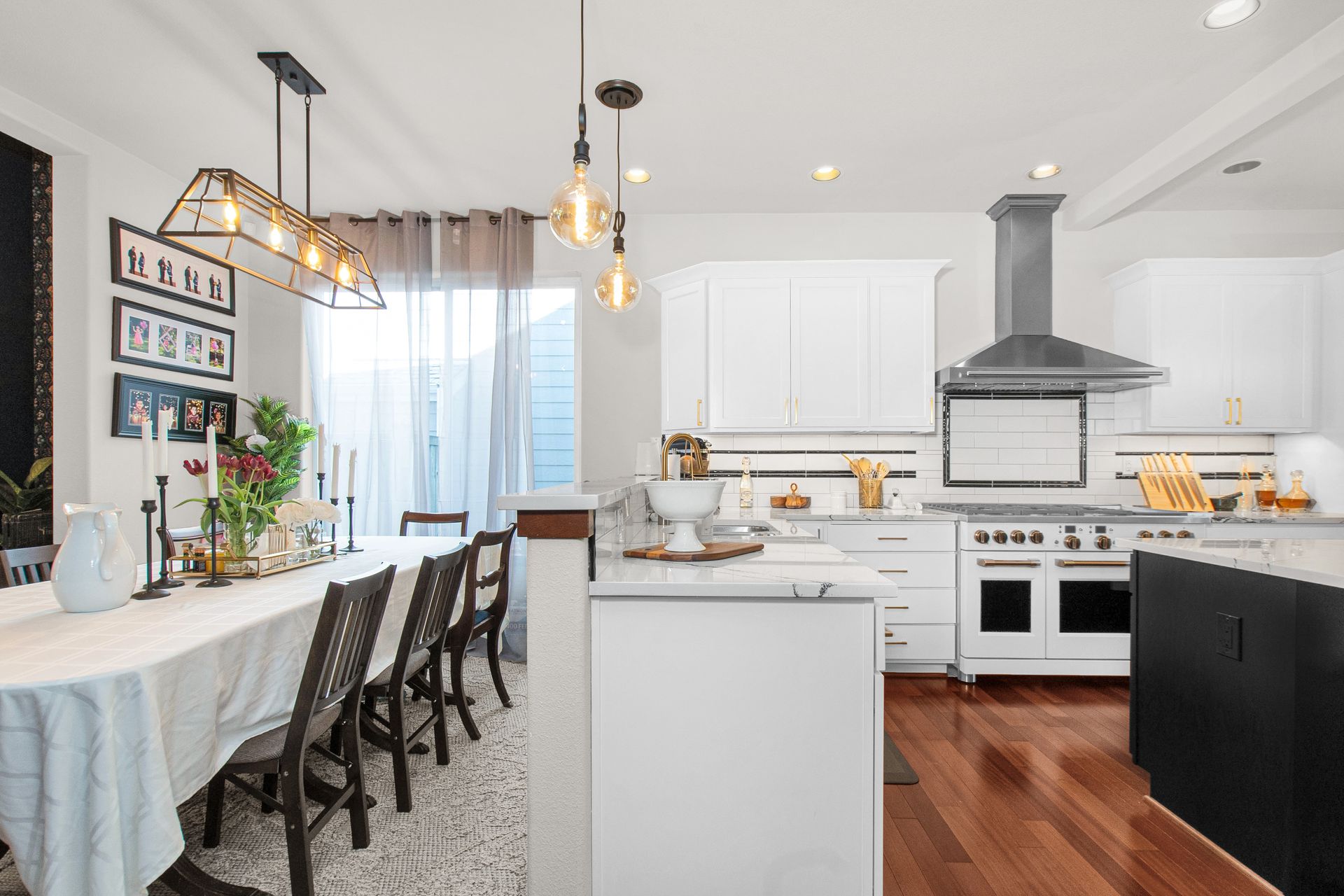 A kitchen with a long table and chairs and a large island.