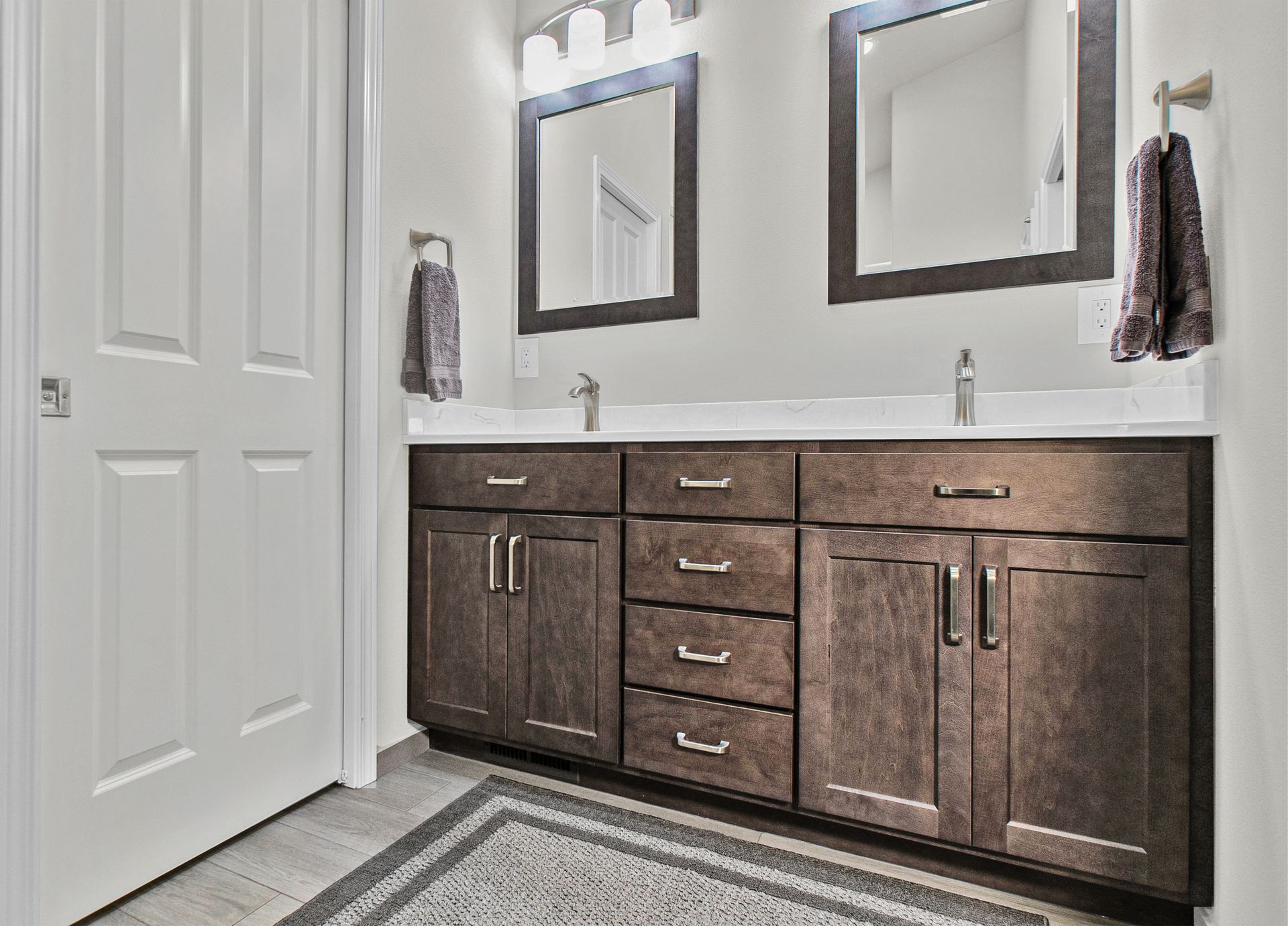 A bathroom with two sinks and two mirrors.