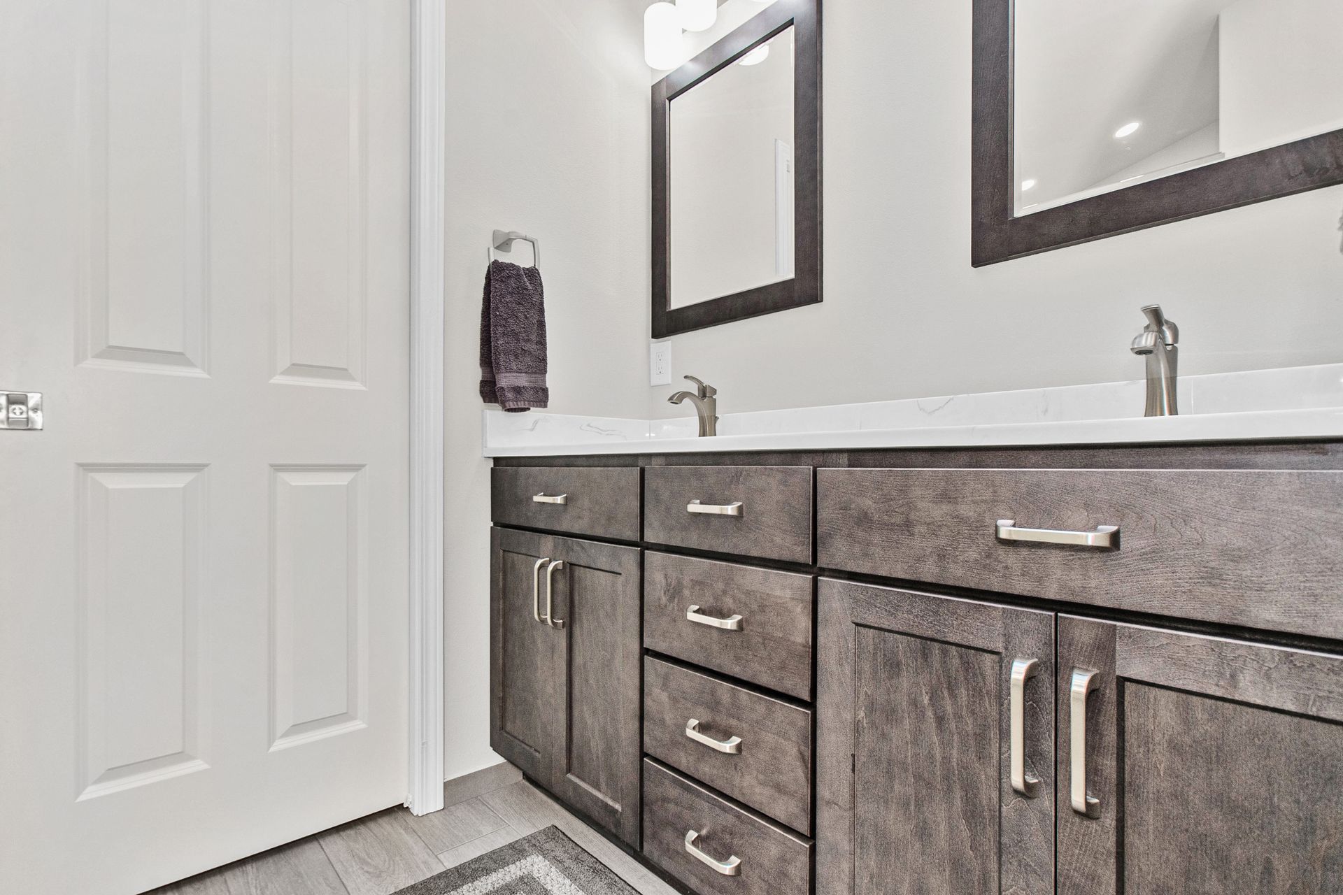 A bathroom with two sinks and two mirrors.