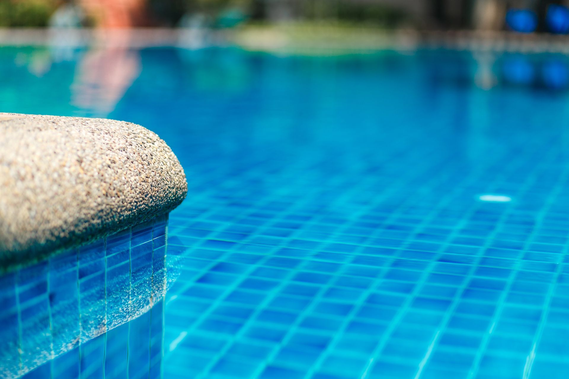 Pristine pool with clear water and tiled edge, showing expert pool maintenance in Overland Park, KS 