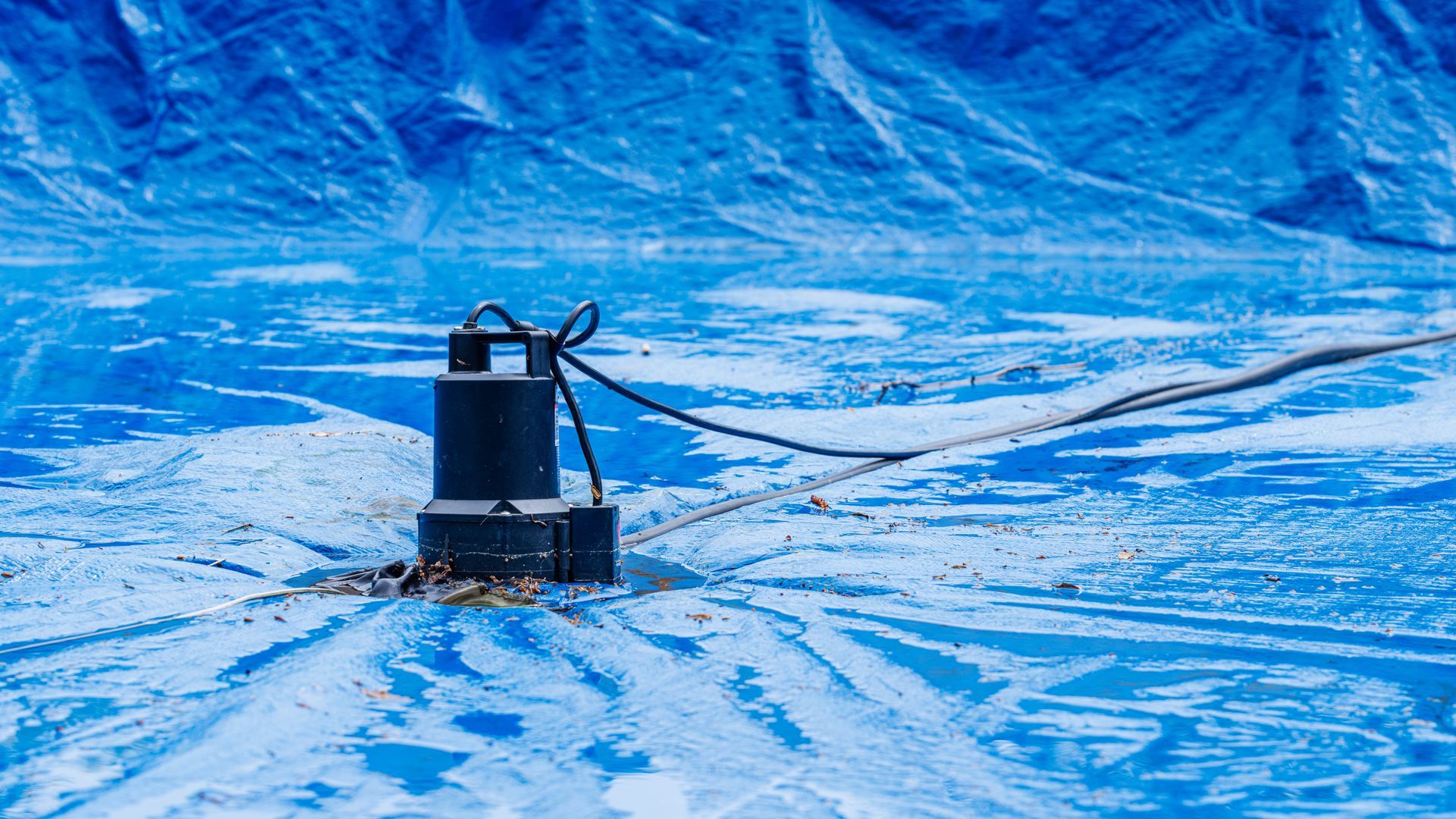 Pool water pump showcasing swimming pool winterization with cover and winter preparation tools. Pool water pump showcasing swimming pool winterization with cover and winter preparation tools.