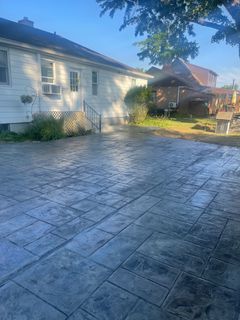 There is a concrete driveway in front of a house.