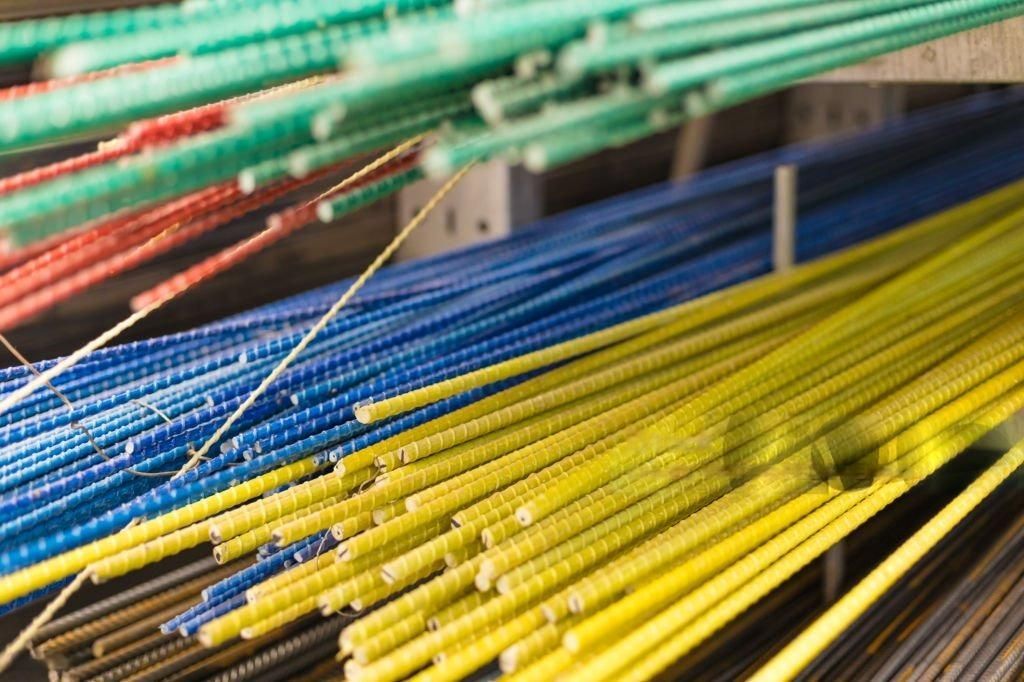 Colorful fiberglass rebar bundles in green, red, blue, and yellow.
