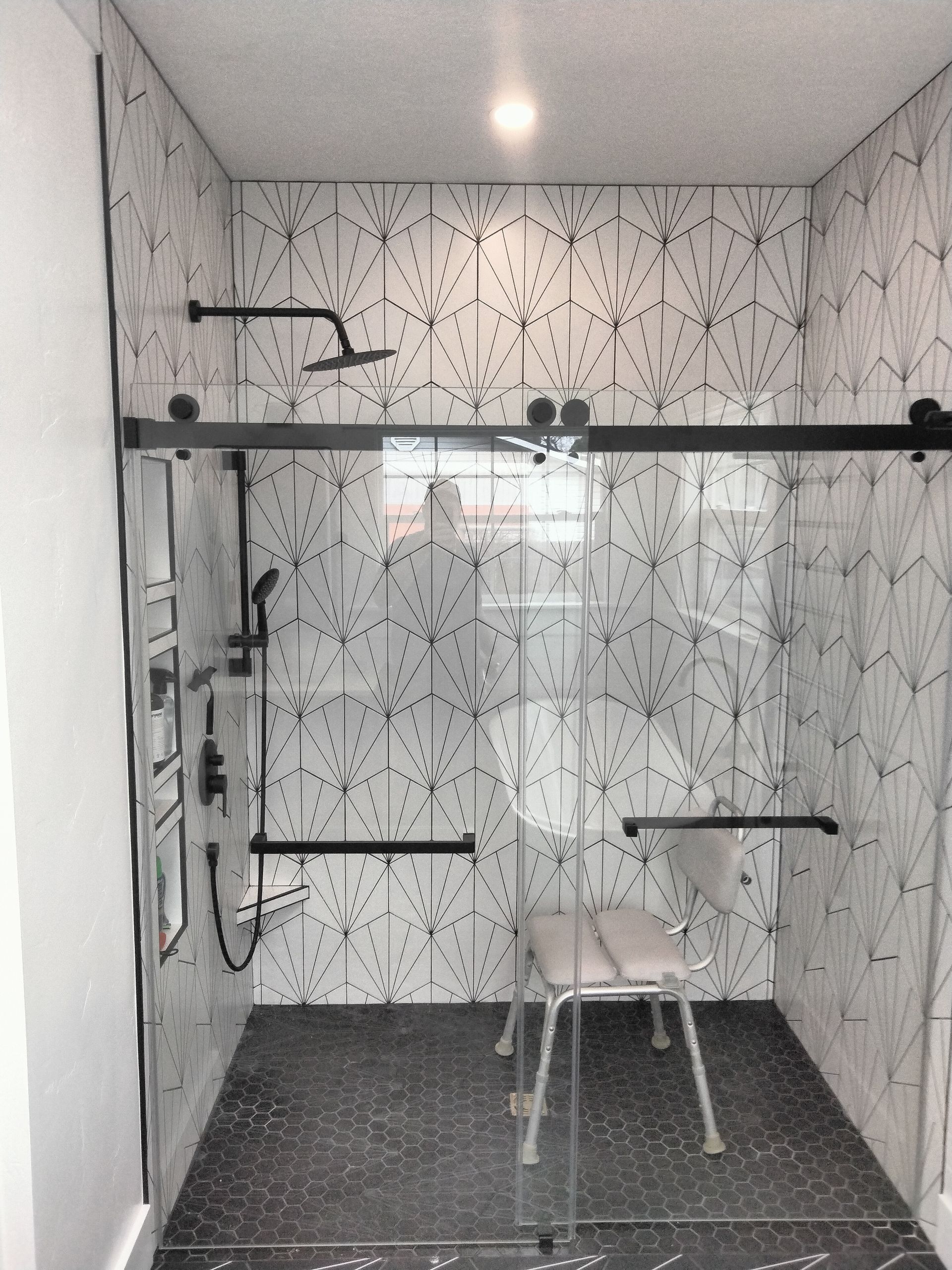 A man is hammering a nail into a piece of wood.