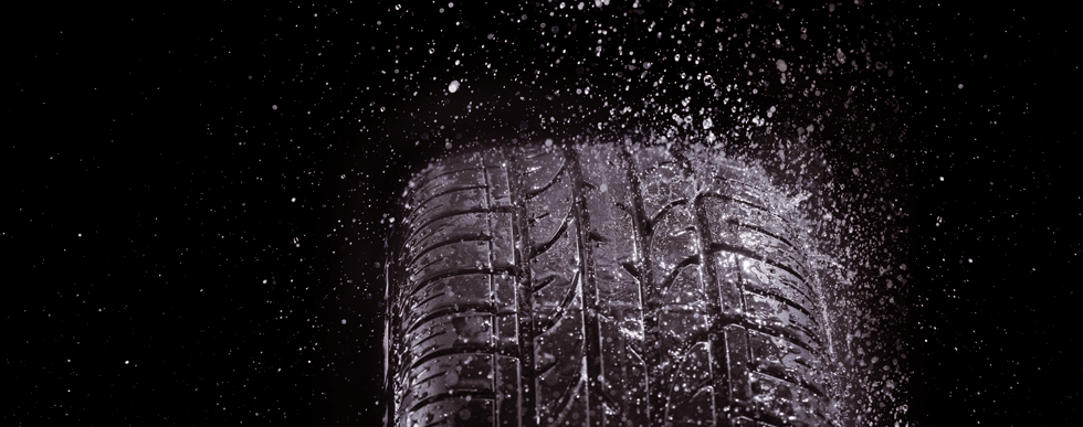 Water spray bouncing off a car tyre