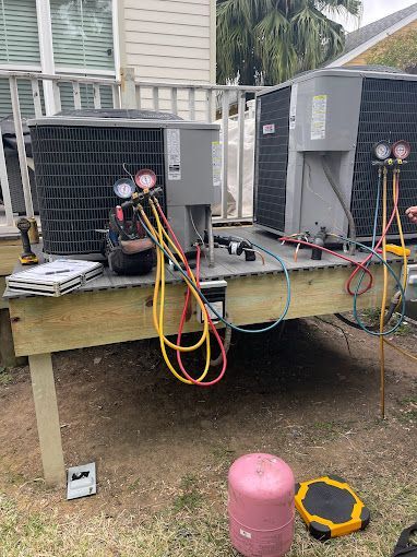 A couple of air conditioners are sitting on top of a wooden table.