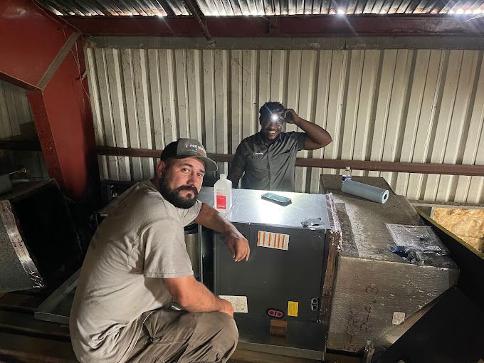 Two men are sitting next to each other in a room.