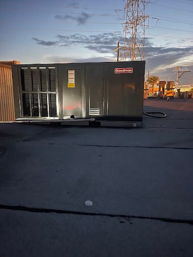 A large box is sitting on the ground in a parking lot.