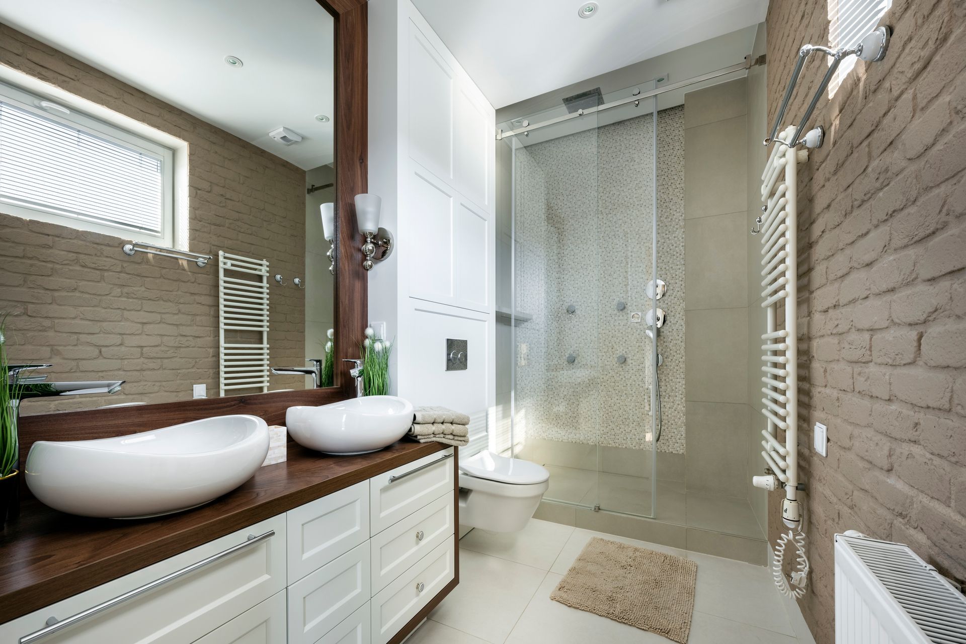A modern bathroom with wooden finishing and custom glass shower doors.