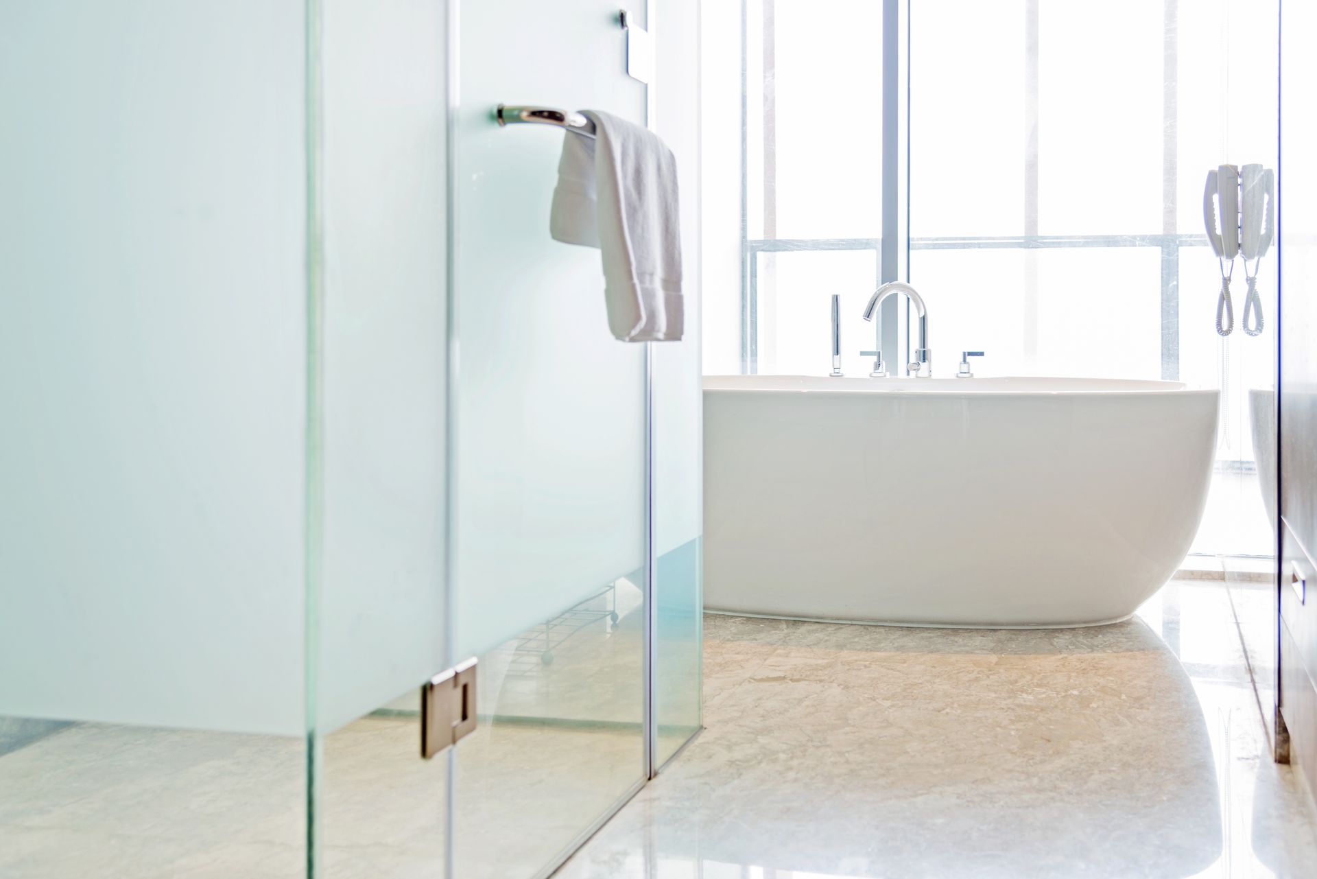 A modern bathroom in a luxury home with custom glass shower doors.