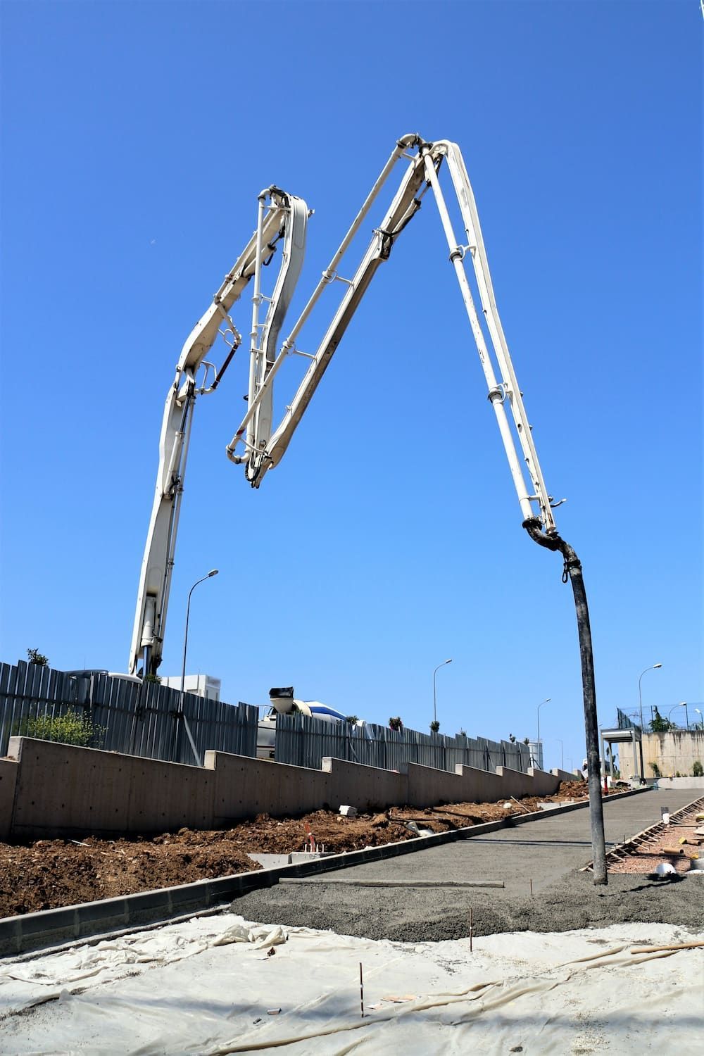 A Concrete Pump is Being Used to Pour Concrete on a Construction Site — Aussie Mad Pumping In Childers, QLD