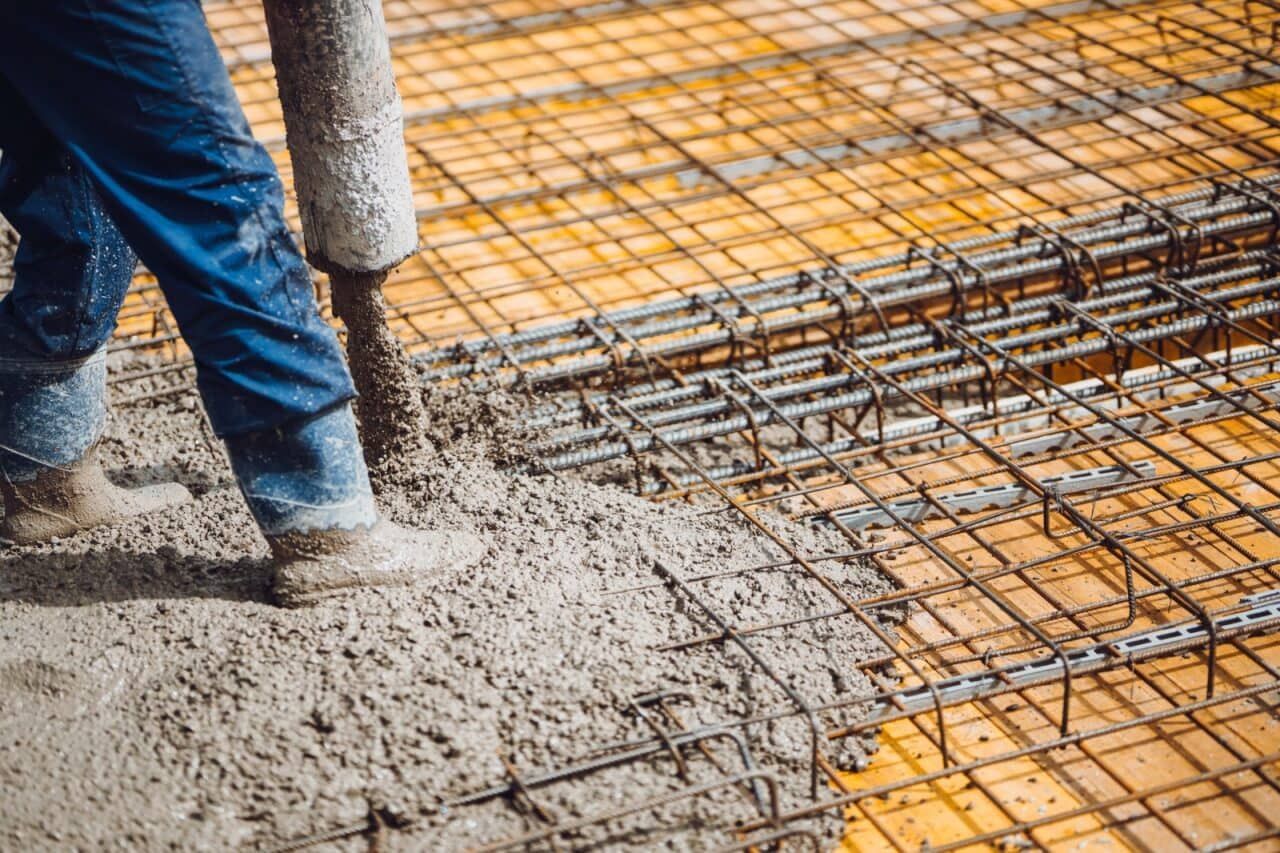 A Man is Pouring Concrete on a Construction Site — Aussie Mad Pumping In Hervey Bay, QLD