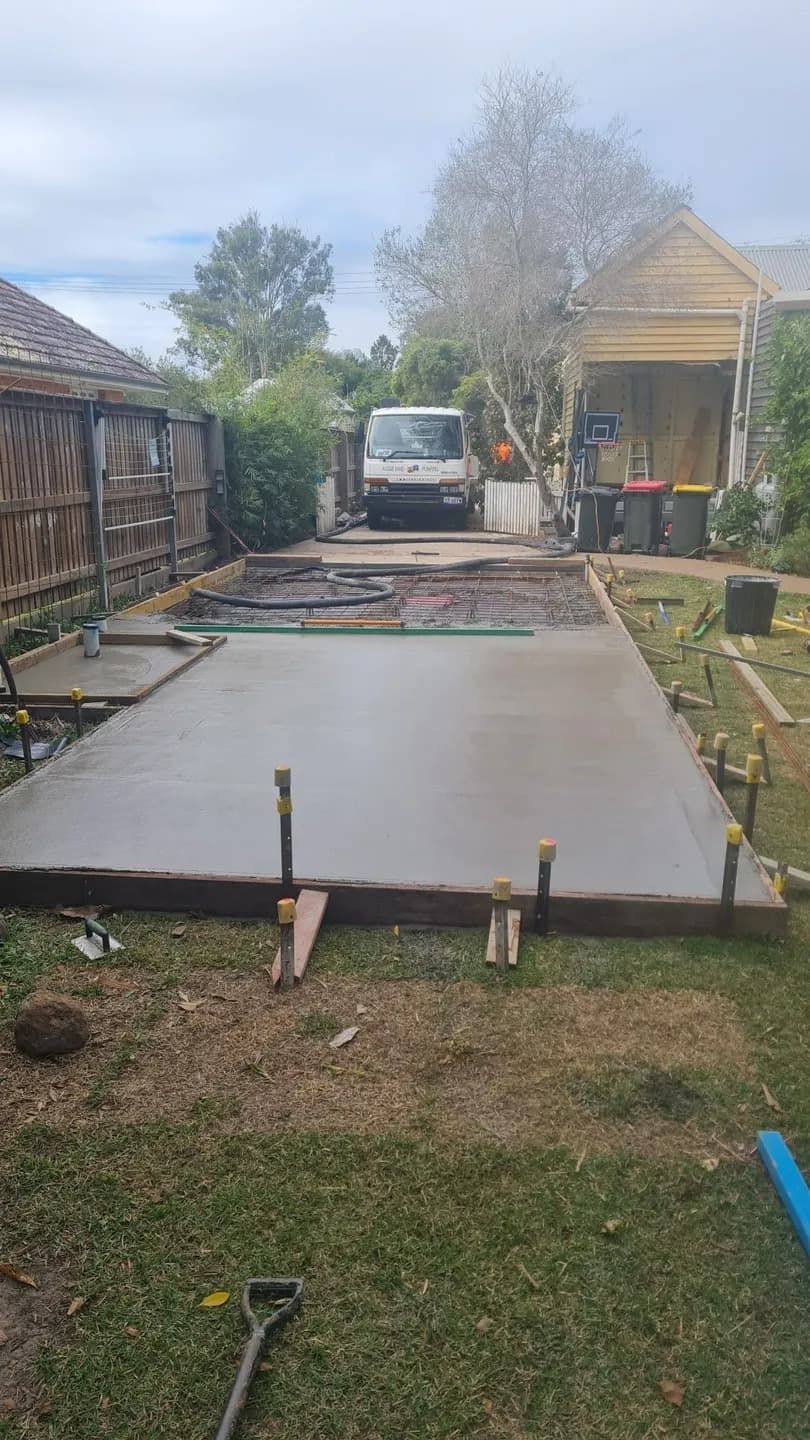 A Concrete Driveway is Being Built in the Backyard of a House — Aussie Mad Pumping In Wondunna, QLD