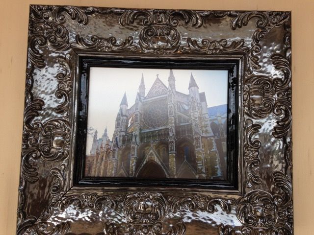 A picture frame with a picture of a castle in it