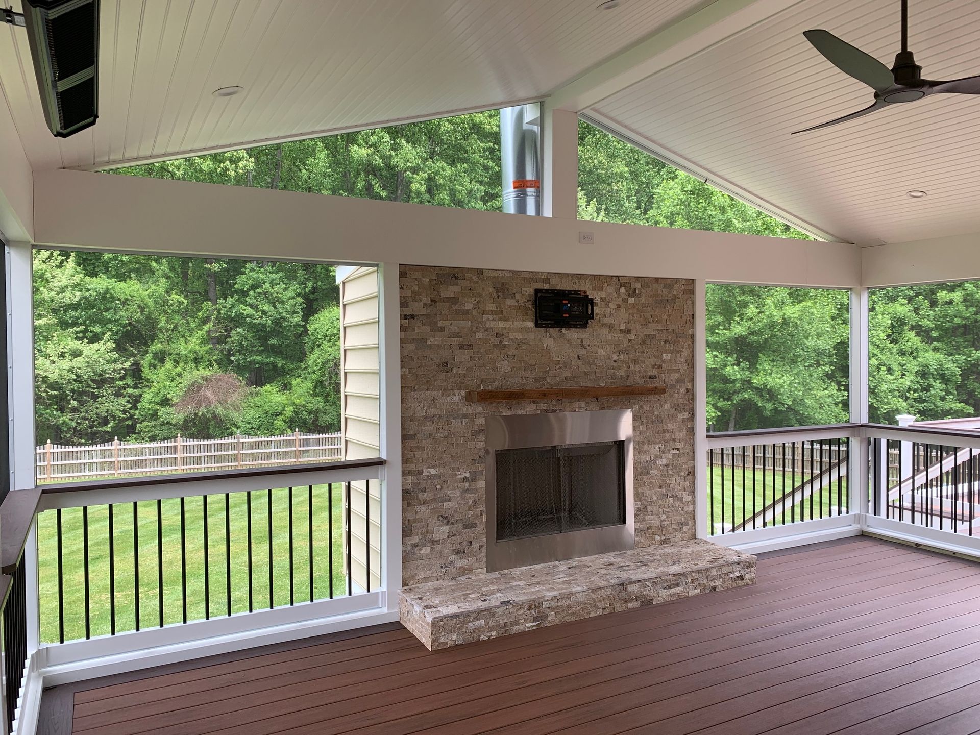 A patio with a stone wall and stairs in the background