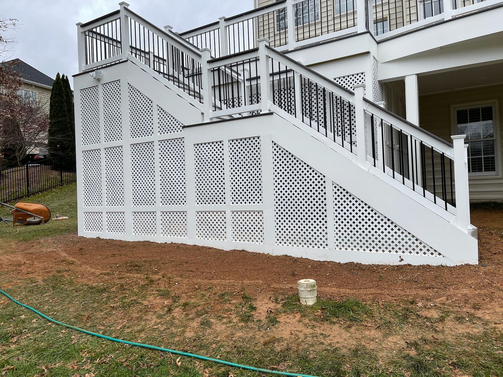 A white deck with stairs leading up to it.