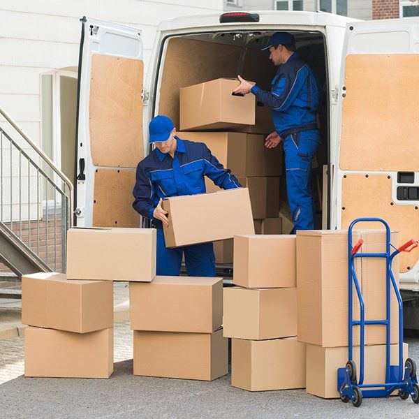 Men Unloading Boxes on Street — Columbus, GA — Sanera Van Service Inc.