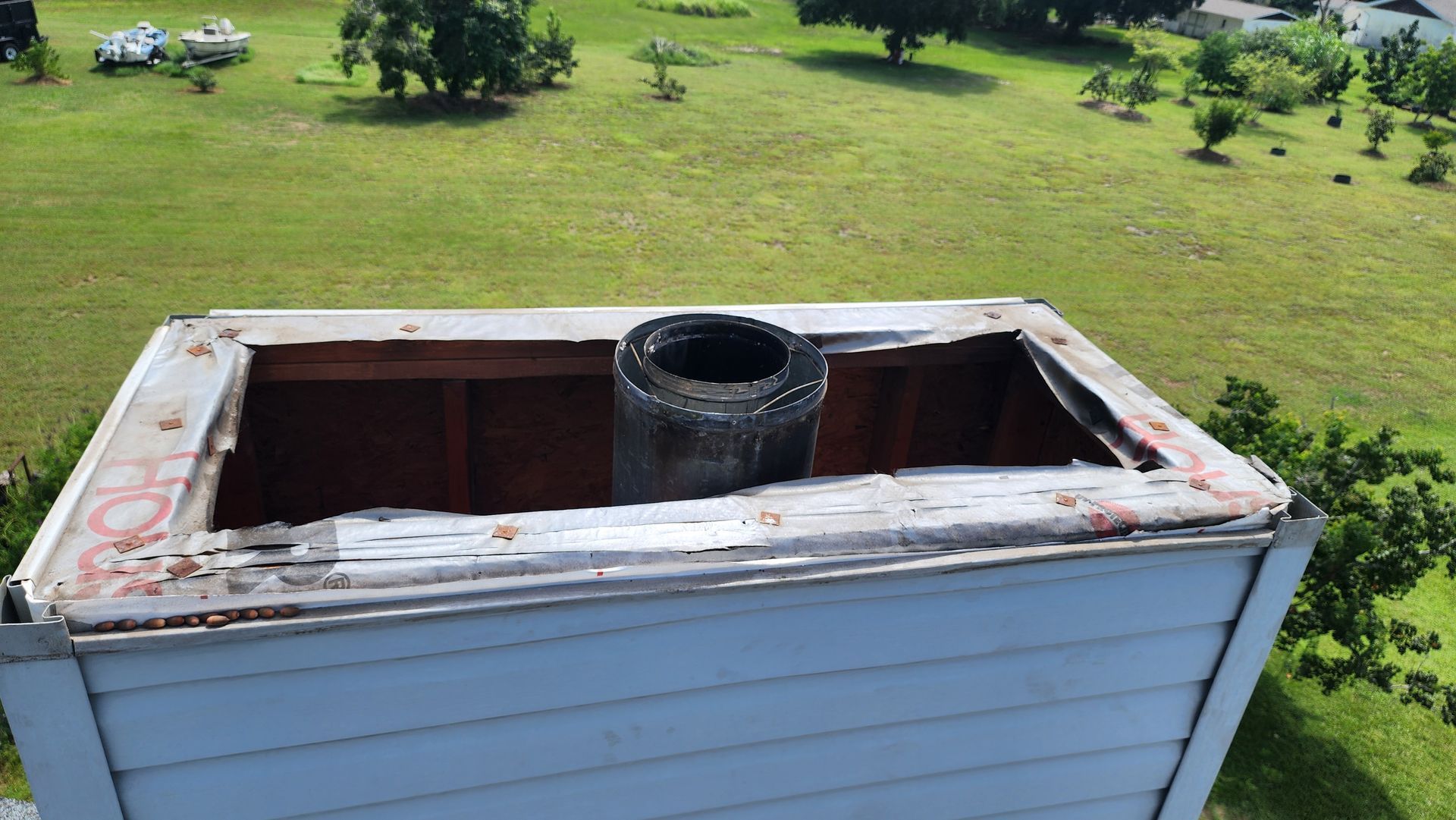 A chimney on top of a house with a hole in it.