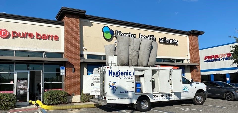 A white truck is parked in front of a building.