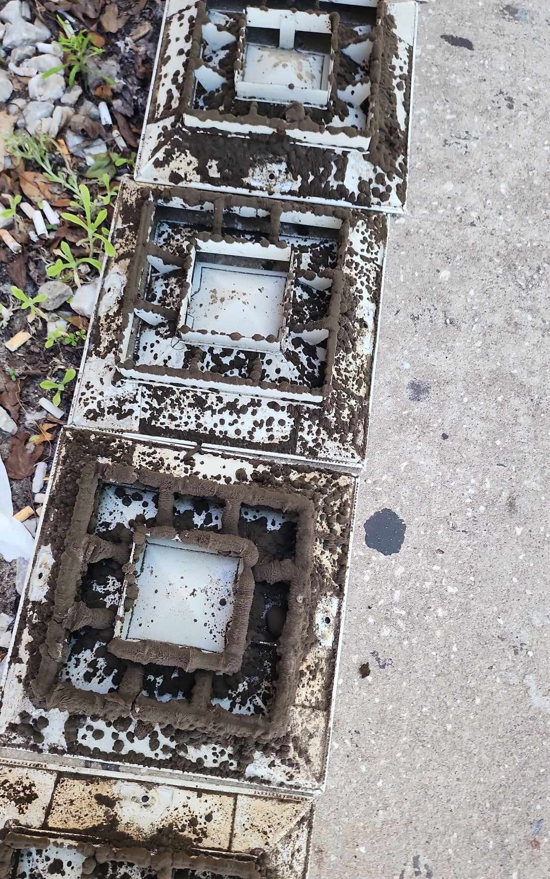 A row of dirty lanterns sitting on top of a concrete surface.