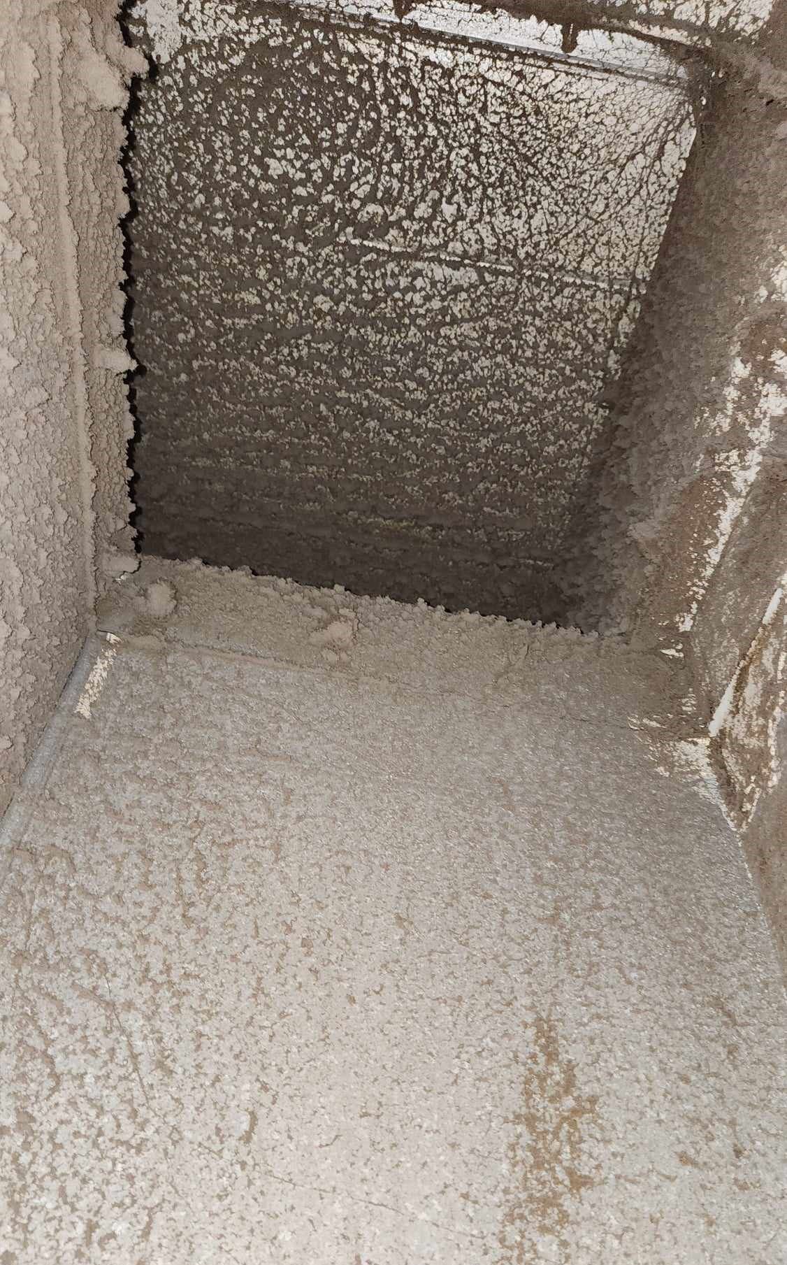 A dirty air vent with a lot of dust on it.