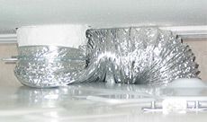 A silver duct is sitting on top of a white surface.