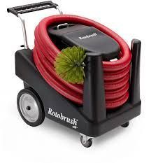 A black cart with a red hose and a green brush on it.