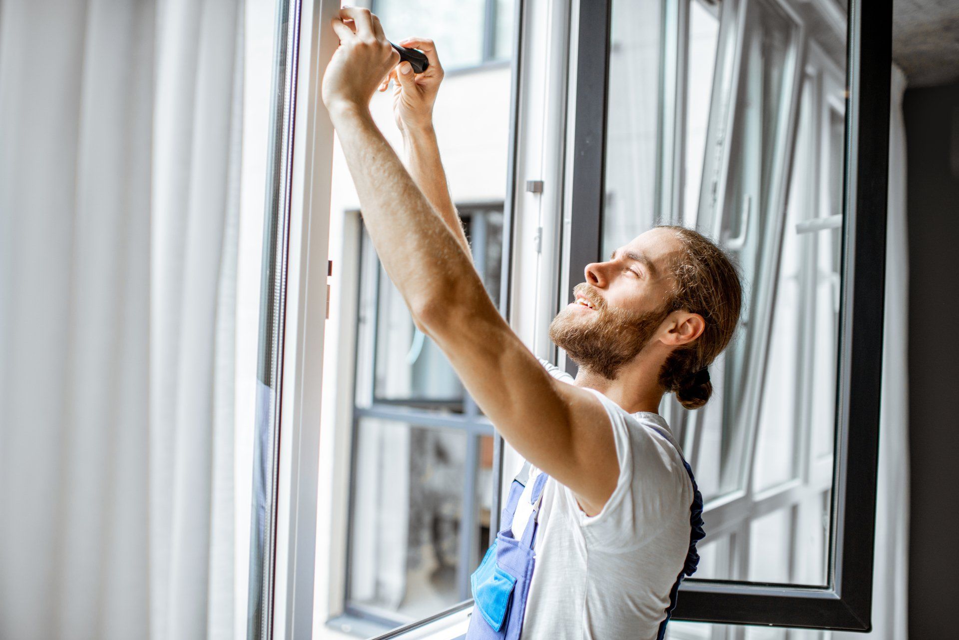 man replacing an indoor window