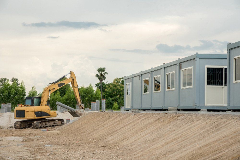 A Yellow Excavator Works on a Dirt — East Coast Containers Shipping Containers and Transport in Chevallum, QLD