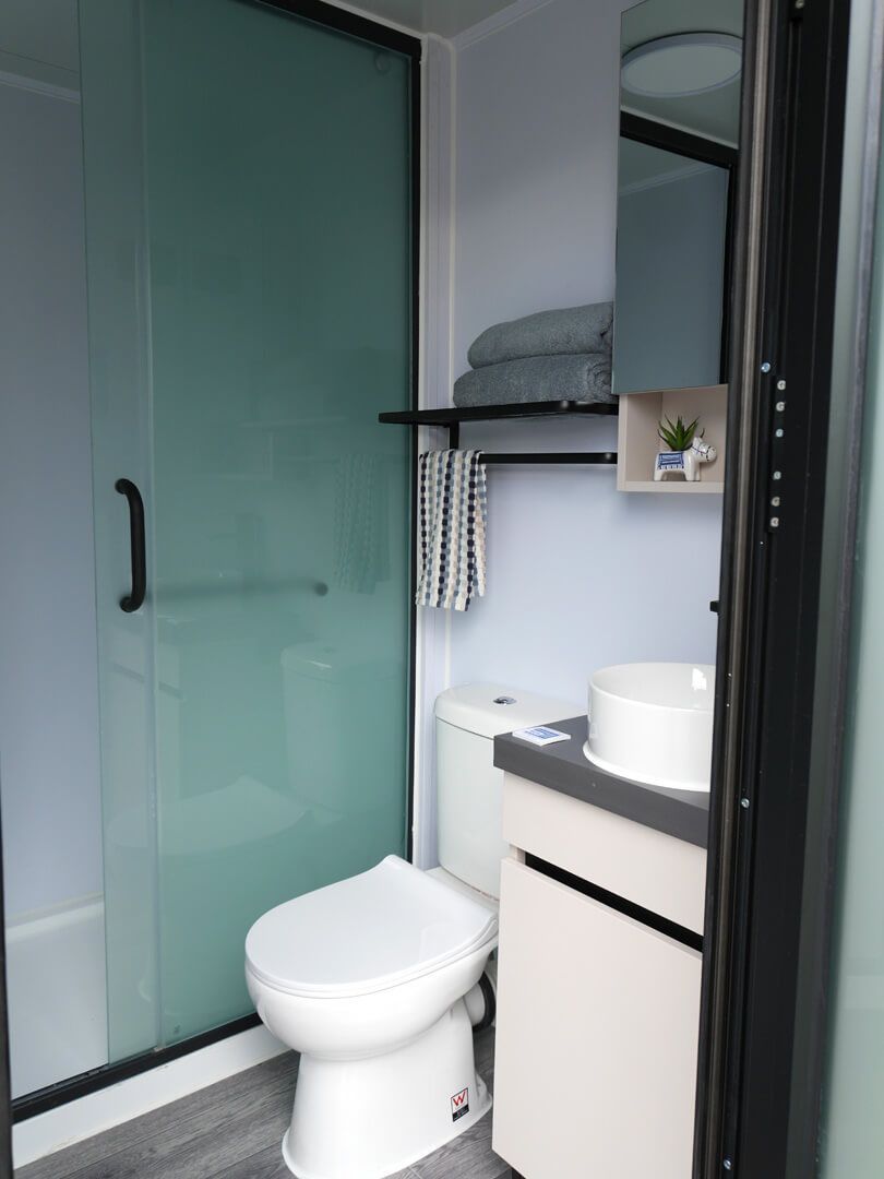 Small Bathroom With Frosted Glass Shower Door — East Coast Containers Shipping Containers and Transport in Chevallum, QLD