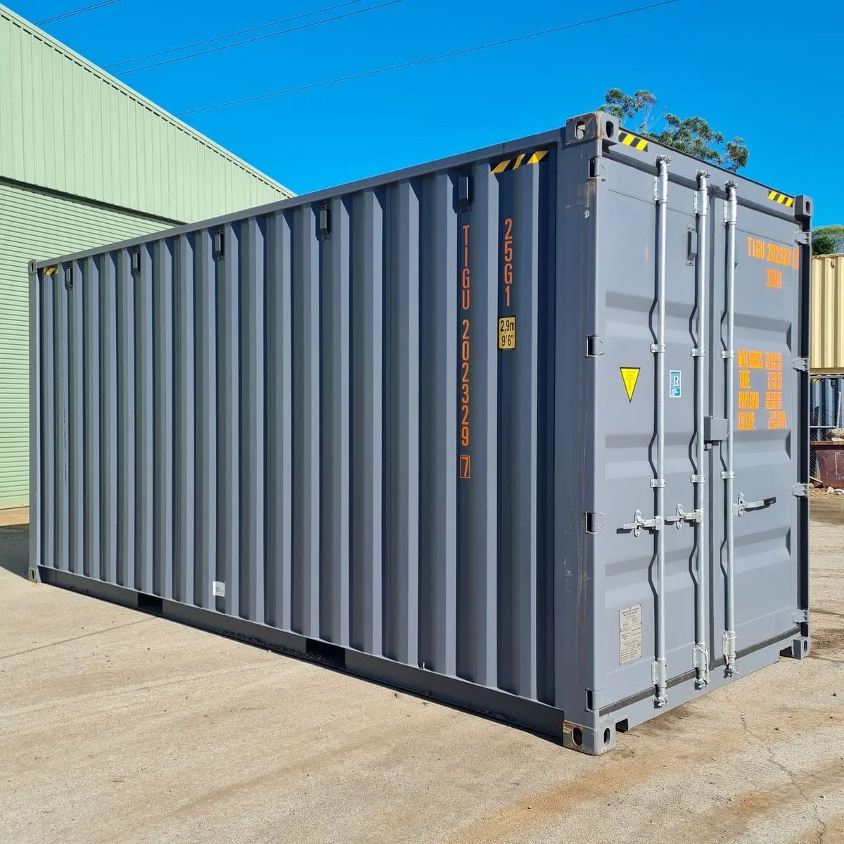 Shipping Container With Orange Text Stands
