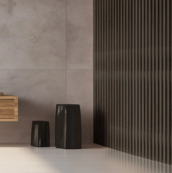 Baño moderno con paredes grises, paneles verticales oscuros, dos taburetes negros y mueble de madera.