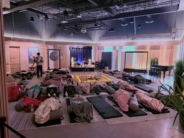 Sound bath setup with crystal singing bowls and meditation cushions for Kundalini activation session in Toronto